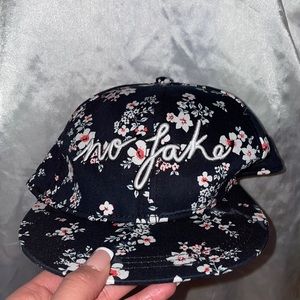Floral hat from H&M with the words “no fake” stitching on front and with tags.